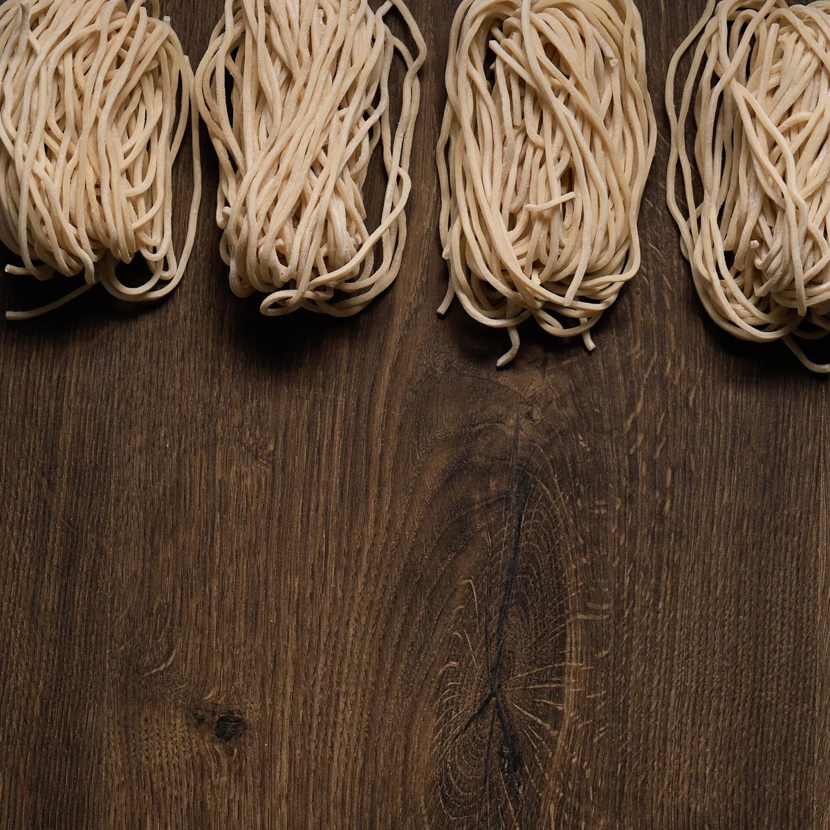 Fresh raw wheat noodles, ready to cook — artisan production